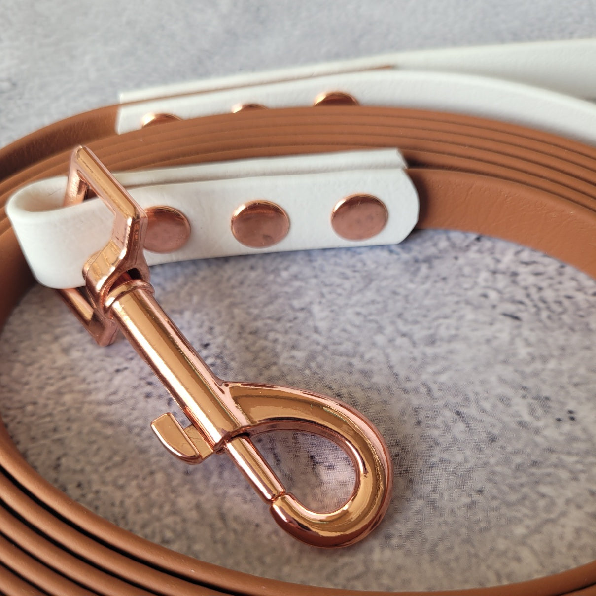 Light tan(brown) and white leash. Rose gold hardware with 2.75" clasp