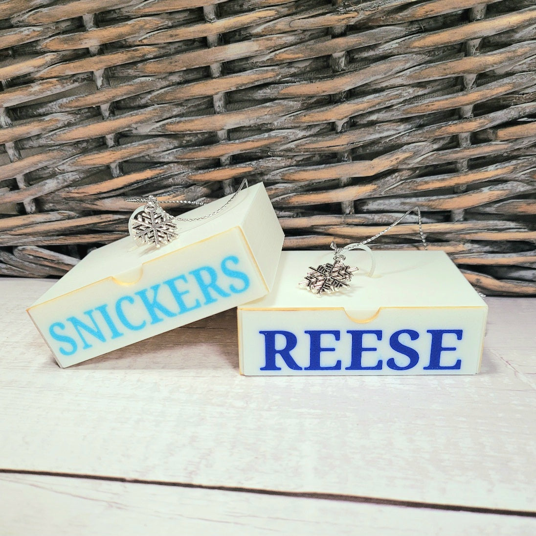 Light blue for Snickers and Royal blue for Reese in font in Simple font in caps