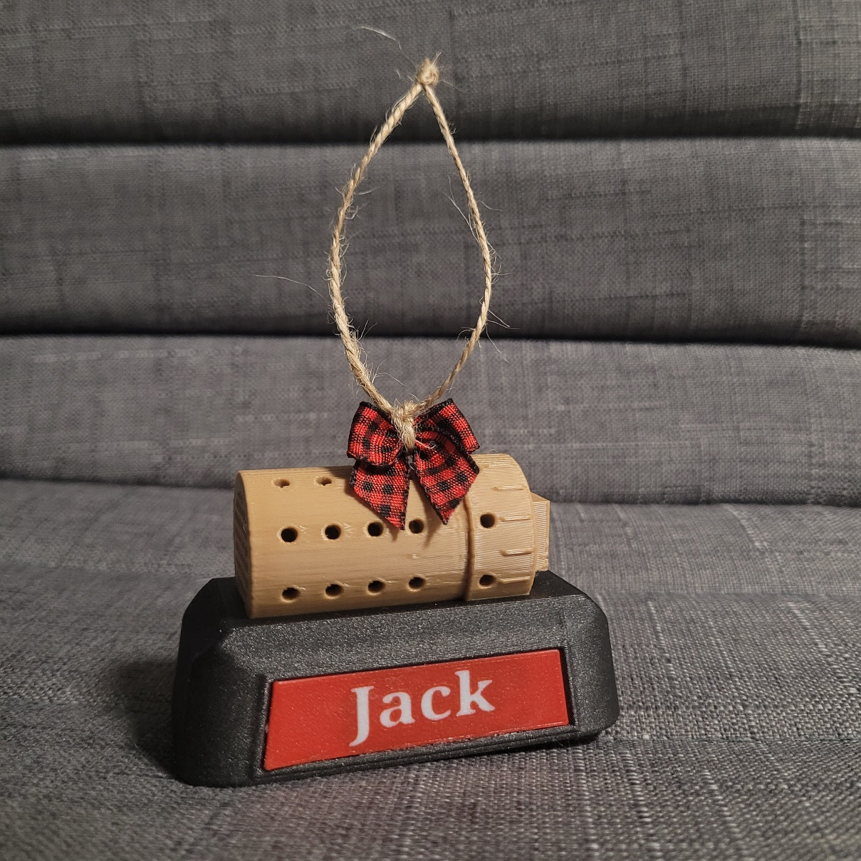 White font, red plate witb red and black Buffalo check bow with simple font 