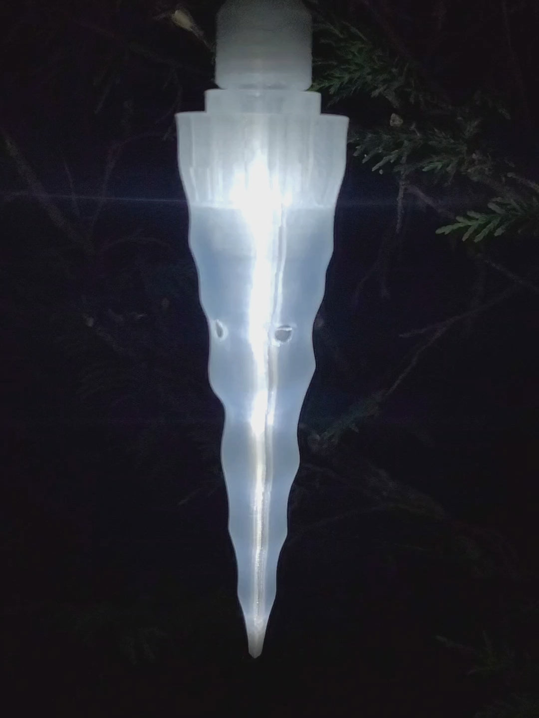This is a single Icicle Vessel that has a metal hook and is lit up at night.