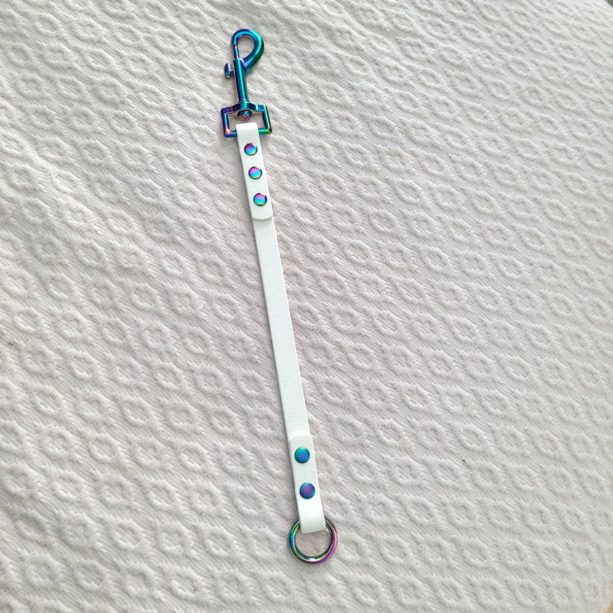 White with rainbow hardware. Clasp is 2.75" long 