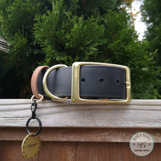 Black and brass hardware with a brown (light tan) strap keeper